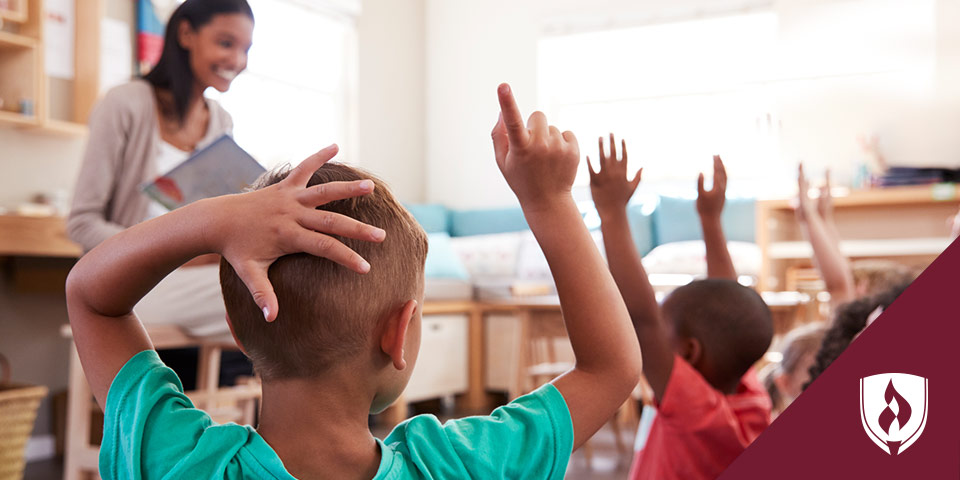 preschool children raising their hands