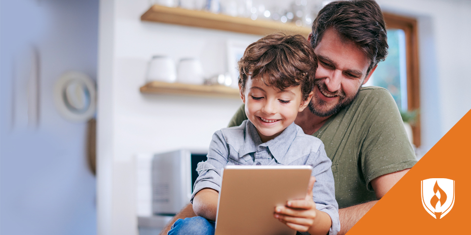 dad and son reading on a tablet