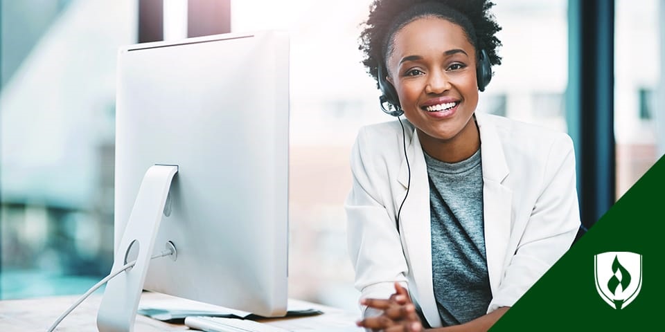 Woman smiling with headset at computer