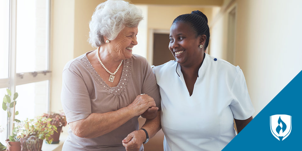 female nurse walking with older female patient