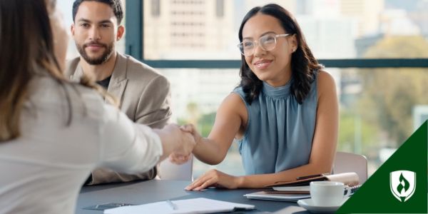 An HR representative shakes hands with a job applicant