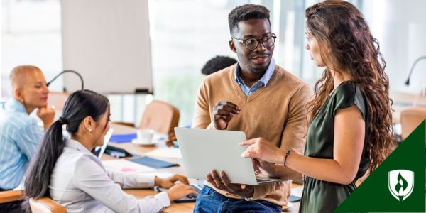 A financial analyst advises their boss at a finance meeting