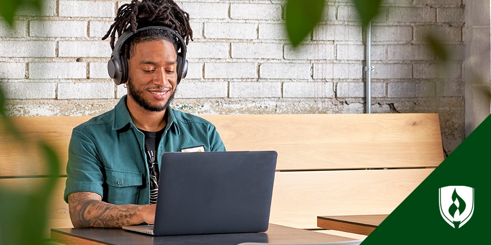 photo of a graphic designer working at a desk representing the "perks of being a graphic designer"