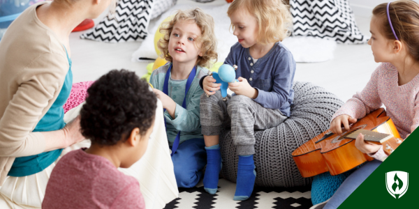 A childcare provider sits in a circle with children holding musical instruments