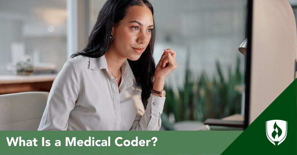 A medical coder jots a note while looking at her computer screen in an office