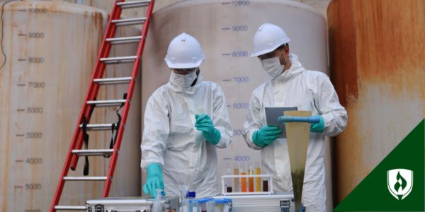 Two environmental health specialists test the public water supply