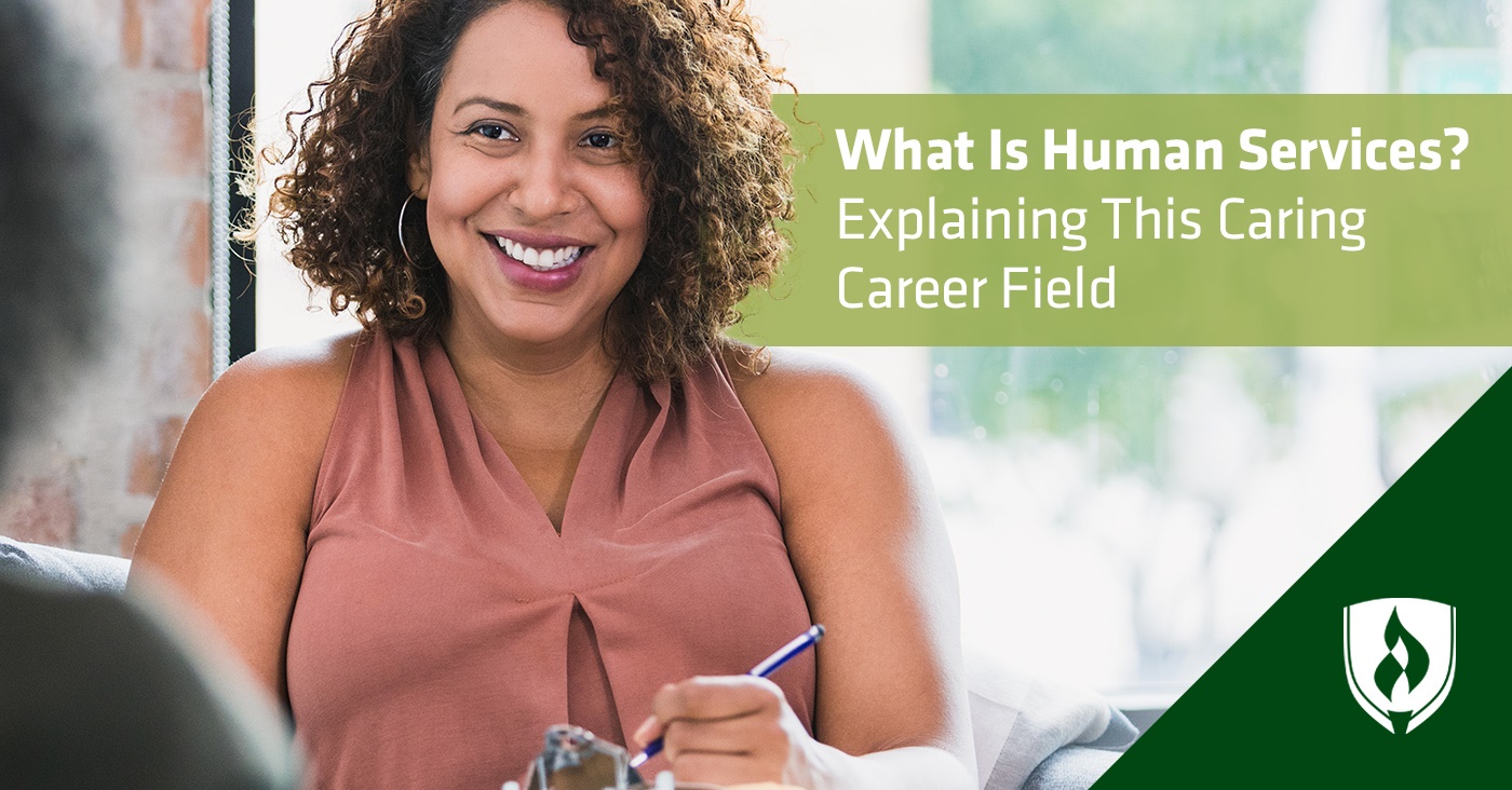 photo of a human services professional smiling at a client and writing on a clipboard