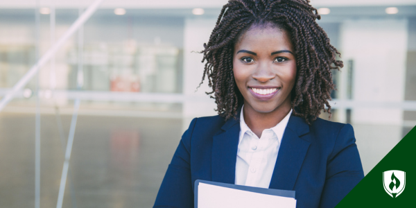 A grinning immigration paralegal holds a case file