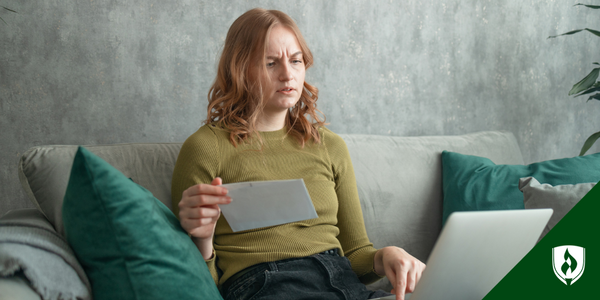 A woman sits at her computer, reviewing her TEAS test results and looking concerned