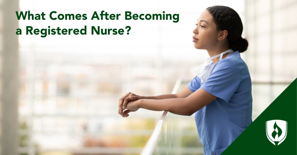 A nurse looks out over the hospital courtyard