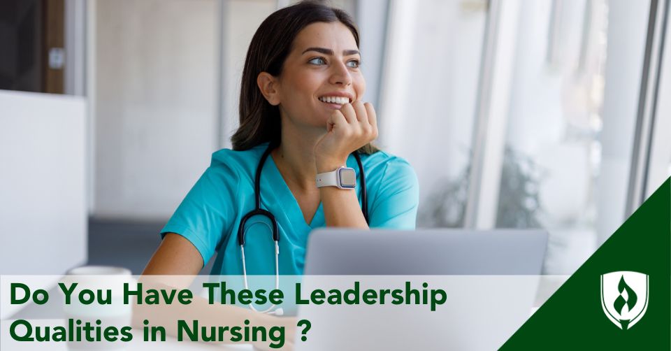 A nurse smiles while sitting at a computer