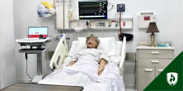 Nursing simulation lab at Rasmussen University shows a mannequin in a hospital bed