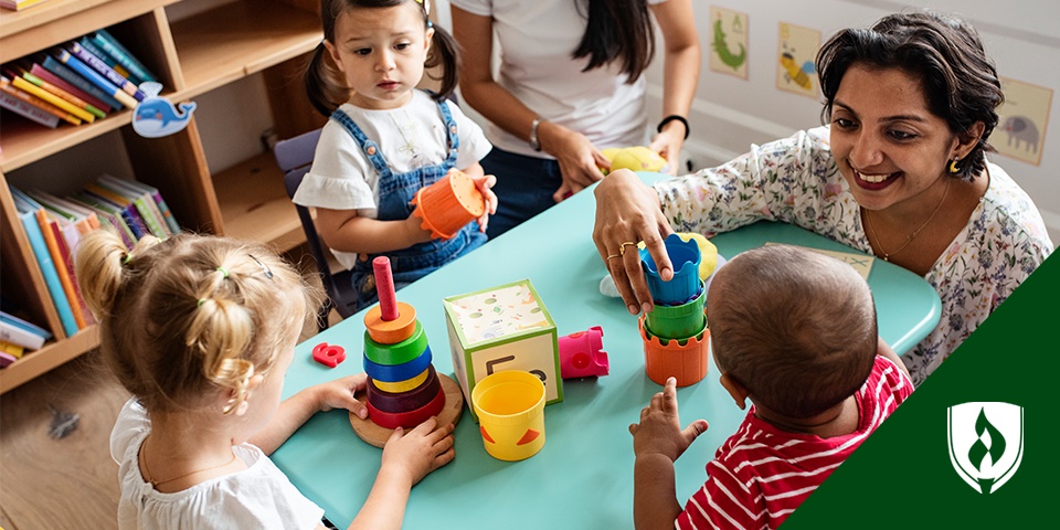 photo of an early childhood teacher assistant playing with preschoolers