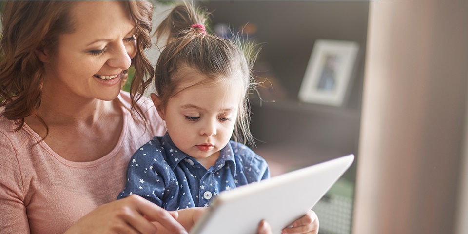 photo of a mom and toddler playing on a tablet