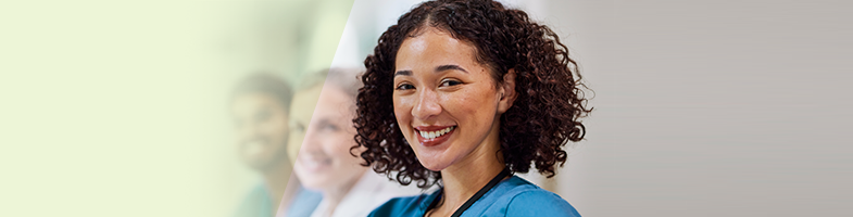 Smiling nurse in blue scrubs